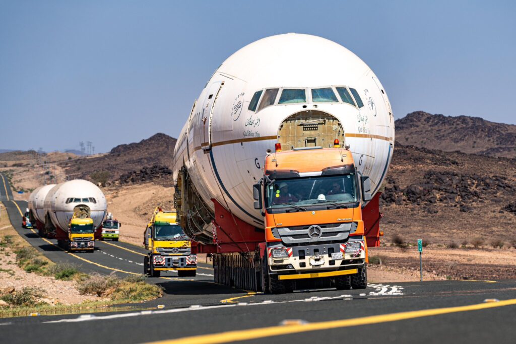 three saudia planes being transferred on trucks from jeddah to riyadh to become a part of boulevard runway